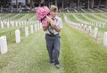 Boyscout placing 85, 000 US Flags at Annual Memorial Day Event, Los Angeles National Cemetery, California, USA Royalty Free Stock Photo