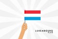 Vector cartoon illustration of human hands hold Luxemburg flag Royalty Free Stock Photo