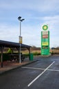 BP petrol station forecourt empty car park and picnic benches on overcast day