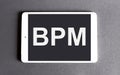 BPM concept - word on a digital tablet on the gray background