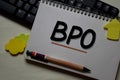 BPO - Business Process Outsourcing write on a book isolated on office desk