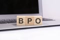 bpo - wooden cubes with letters on a laptop keyboard