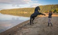 Girl and trained black stallion on the shores of Lake Bracciano in Lazio, Italy