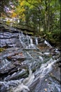 Beautiful cascade waterfall in the autumn forest, silky smooth stream Royalty Free Stock Photo