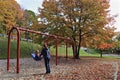 Mother and child enjoy the play of swing at Kelvin Grove Park in the heart of Bracebridge