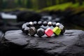 bracelet with bright beads contrasted against a dark basalt rock