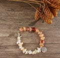 Bracelet with charm on wooden background