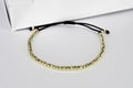 Bracelet gold made with 585 14K Gold balls and cord Royalty Free Stock Photo