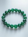 Bracelet with green emerald beads. Royalty Free Stock Photo