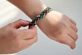 Bracelet made of fabric ropes on a woman`s hand