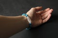 Bracelet made of natural stones. Blue apatite and rock crystal dZi bead. Handmade jewelry. Handmade bracelets on a black modern Royalty Free Stock Photo