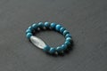 Bracelet made of natural stones. Blue apatite and rock crystal dZi bead. Handmade jewelry. Handmade bracelets on a black modern Royalty Free Stock Photo