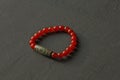 Bracelet made of natural stones. Carnelian Tibetan dZi bead. Handmade jewelry. Handmade bracelets on a black modern background