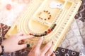 Bracelets made of natural stones. Girl creates handmade jewelry close-up. The mystic of amulets, beads.