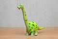 Brachiosaurus dinosaurs toy on wooden table.