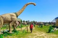 Brachiosaurus sculpture and other dinosaur models at outdoor show