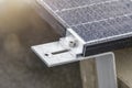 Bracket for mounting solar panels. Mounting a solar panel close-up on the roof of a residential building, water drops