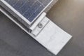 Bracket for mounting solar panels. Mounting a solar panel close-up on the roof of a residential building, water drops