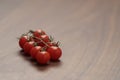 bracnh of fresh cherry tomatoes of wood table Royalty Free Stock Photo