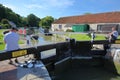 Bradford on Avon, UK - AUGUST 13, 2017: People enjoying a sunny day at Canal Wharf with colorful barges on Kennet and Avon Canal