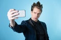 Brag about your success on social networks. A young man has received an achievement and takes a selfie. Royalty Free Stock Photo