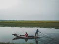 Brahmanbaria Man rowing boat with bamboo Royalty Free Stock Photo