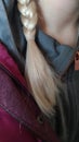 tight braid of a girl with a ponytail blonde delicate color