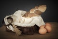 Braided bread in a wicker basket and eggs on the table Royalty Free Stock Photo