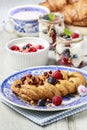 Braided danish bun made of puff pastry decorated with fresh fruits