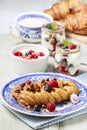 Braided danish bun made of puff pastry decorated with fresh fruits