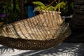 Braided hammock in palm leaf shadow on beach. Empty hammock of abandoned luxury resort