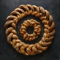 A braided loaf of bread on a wooden serveware in a circular pattern