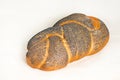 Braided loaf poppy seed challah. Closeup on a light background