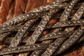 Braided metal strips with scales