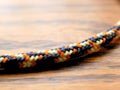 Braided Nylon Rope on Wood Grain Background for Climbing, Camping