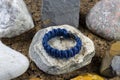 Braided paracord bracelet on the background of stones.