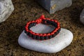 Braided paracord bracelet on the background of stones.