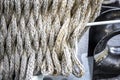 Mooring rope is braided on a metal deck guard of a ship Royalty Free Stock Photo