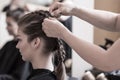Braiding young woman's hair Royalty Free Stock Photo