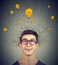 Brain connections. Excited man looking up at many ideas light bulbs above head. Eureka concept Royalty Free Stock Photo