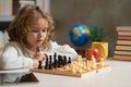 Brain development and logic. Early development. Boy thinking about chess. The concept of learning and growing children Royalty Free Stock Photo