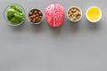 Brain food concept with peanut, hazelnut, seed-oil, spinage on gray background top view copyspace Royalty Free Stock Photo