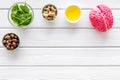 Brain food concept with peanut, hazelnut, seed-oil, spinage on white wooden background top view copyspace Royalty Free Stock Photo