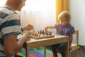 Brain games - father teaches to play chess for his child Royalty Free Stock Photo