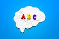 Brain Shaped Puzzle with Colorful ABC Letters on Blue Background Royalty Free Stock Photo