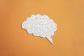 Brain shaped white jigsaw puzzle on orange background,  mental health and problems with memory concept Royalty Free Stock Photo