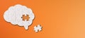 Brain shaped white jigsaw puzzle on orange background, a missing piece of the brain puzzle, mental health and problems with memory Royalty Free Stock Photo