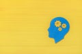 Brain works concept. Thinking, creativity concept of the human head with gears on yellow background Royalty Free Stock Photo