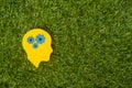 Brain works concept. Thinking, creativity concept of the human head with gears on green grass background