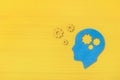 Brain works concept. Thinking, creativity concept of the human head with gears on yellow background